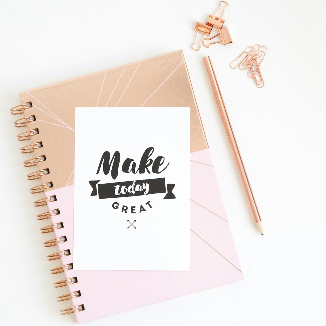 Notebook with handwritten notes and a pen on a wooden desk